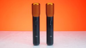 Stylish wireless microphones set against a bold orange backdrop, perfect for audio tech themes.