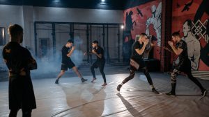 Group of men training in an MMA gym setting, focusing on sparring and techniques.