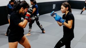 Female martial artists sparring at a training academy in Buenos Aires.