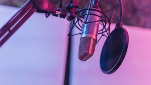 A close-up view of a microphone in a vibrant studio environment, ideal for podcasts and voice recording.