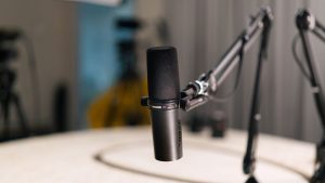 Close-up of a dynamic microphone in a professional studio setting.