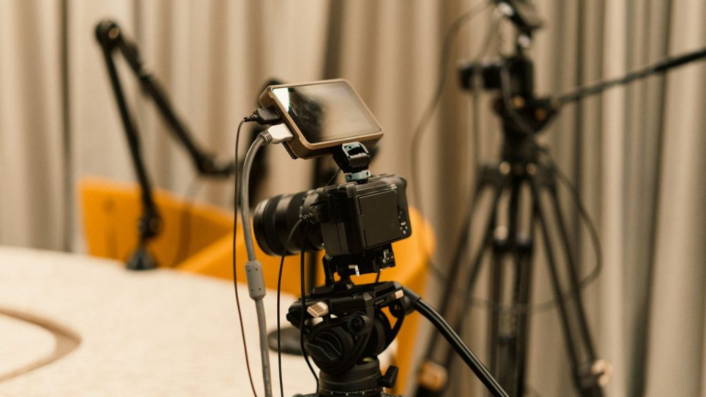 A professional studio with cameras, microphones, and other equipment ready for recording or live streaming.