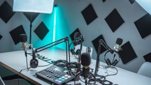 Sleek podcast studio setup featuring microphones, audio mixer, and acoustic panels.