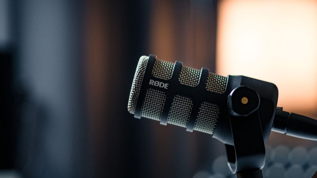 Close-up of a Rode microphone in a studio, emphasizing professional audio equipment.