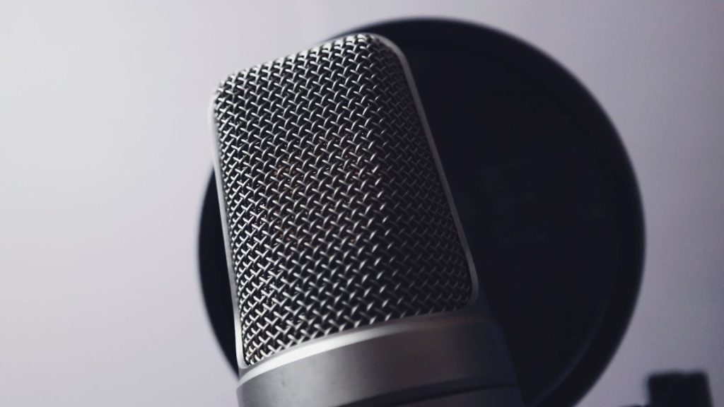 A close-up of a professional microphone in a studio. Ideal for music and broadcasting themes.
