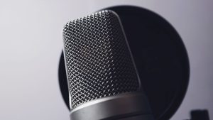 A close-up of a professional microphone in a studio. Ideal for music and broadcasting themes.
