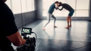 Capturing martial arts practice with professional filming equipment in a gym setting.