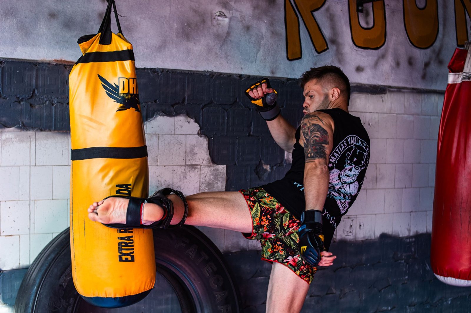 Combattant en short MMA qui frappe un sac de frappe